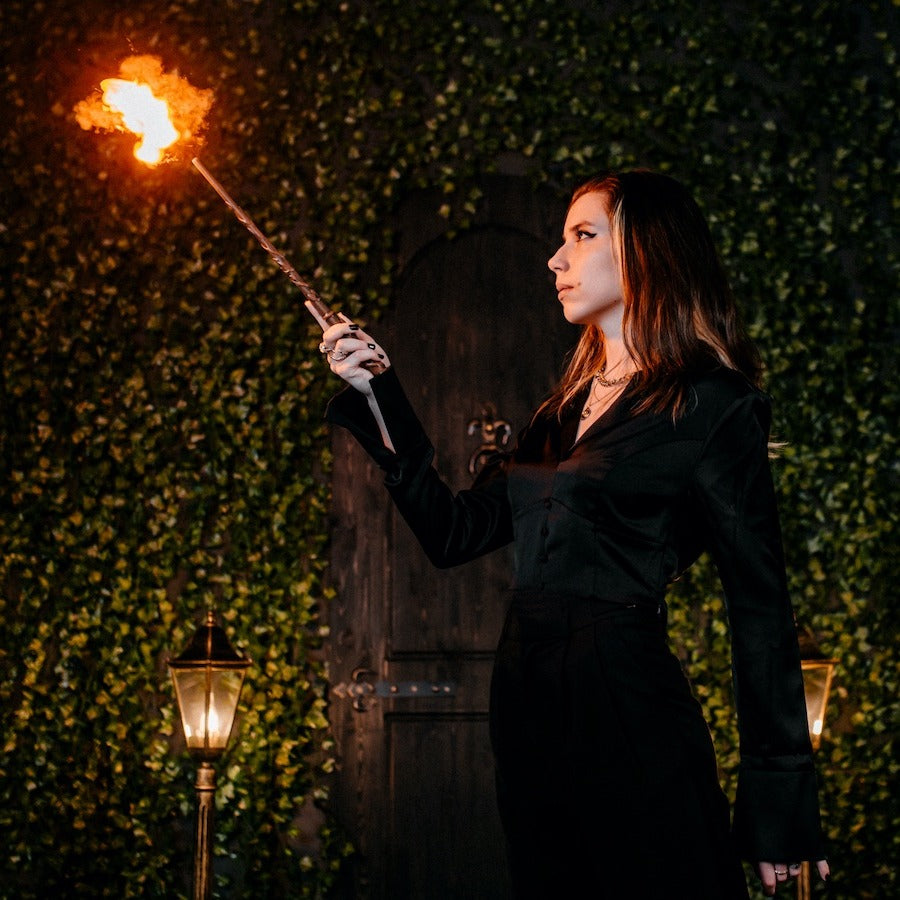 Fire magic wand shooting a real fireball at night